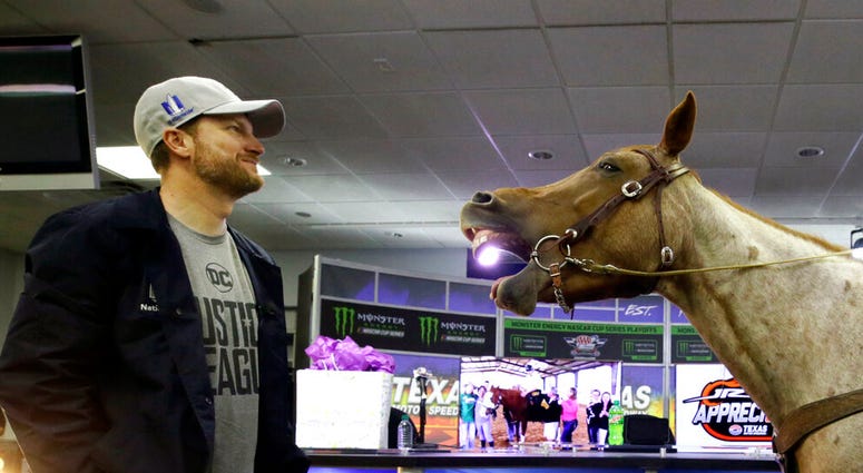 In this Nov. 3, 2017, file photo, Dale Earnhardt Jr., left, looks on as Eddie Gossage, president and CEO of Texas Motor Speedway, AP DO NOT USE
