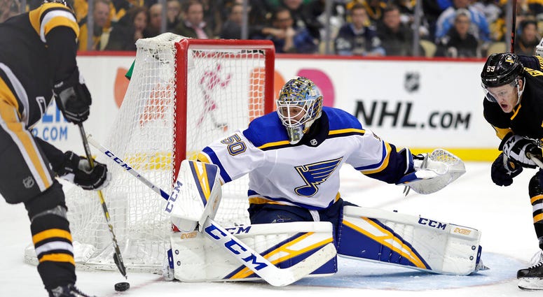 St. Louis Blues goaltender Jordan Binnington (50) blocks a shot by Pittsburgh Penguins' Evgeni Malkin, left, during the second period of an NHL hockey game in Pittsburgh, Saturday, March 16, 2019 St. Louis Blues goaltender Jordan Binnington (50) blocks a shot by Pittsburgh Penguins' Evgeni Malkin, left, during the second period of an NHL hockey game in Pittsburgh, Saturday, March 16, 2019