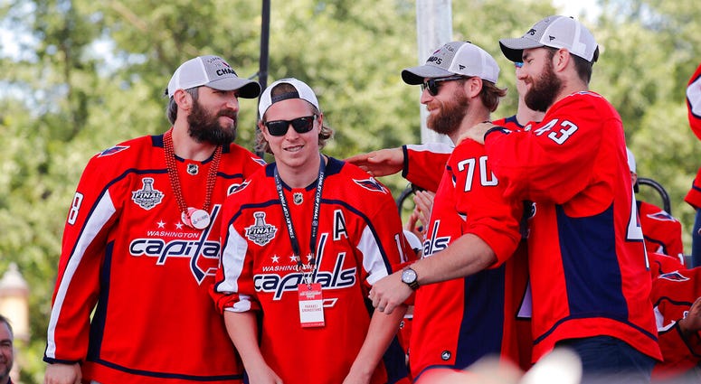 Washington Capitals' Alex Ovechkin (8), of Russia; Nicklas Backstrom (19), of Sweden; Braden Holtby (70); and Tom Wilson (43) greet each other on stage during the Stanley Cup victory celebration on the National Mall in Washington. Washington Capitals' Alex Ovechkin (8), of Russia; Nicklas Backstrom (19), of Sweden; Braden Holtby (70); and Tom Wilson (43) greet each other on stage during the Stanley Cup victory celebration on the National Mall in Washington.