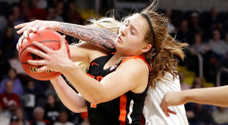 Oregon State guard Mikayla Pivec (0) battles for the ball with Louisville forward Sam Fuehring during the first half of a regional semifinal game in the NCAA women's college basketball tournament, Friday, March 29, 2019, in Albany, N.Y. Oregon State guard Mikayla Pivec (0) battles for the ball with Louisville forward Sam Fuehring during the first half of a regional semifinal game in the NCAA women's college basketball tournament, Friday, March 29, 2019, in Albany, N.Y.