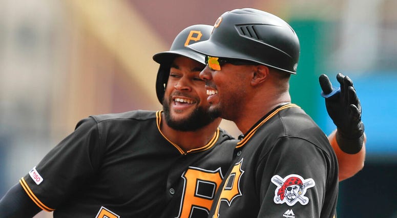 Pittsburgh Pirates Jason Martin, left, puts his arm around first base coach Kimera Bartee after getting his first major league hit off Cincinnati Reds starting pitcher Tanner Roark in the first inning of a baseball game, Saturday, April 6, 2019, in Pittsb Pittsburgh Pirates Jason Martin, left, puts his arm around first base coach Kimera Bartee after getting his first major league hit off Cincinnati Reds starting pitcher Tanner Roark in the first inning of a baseball game, Saturday, April 6, 2019, in Pittsb