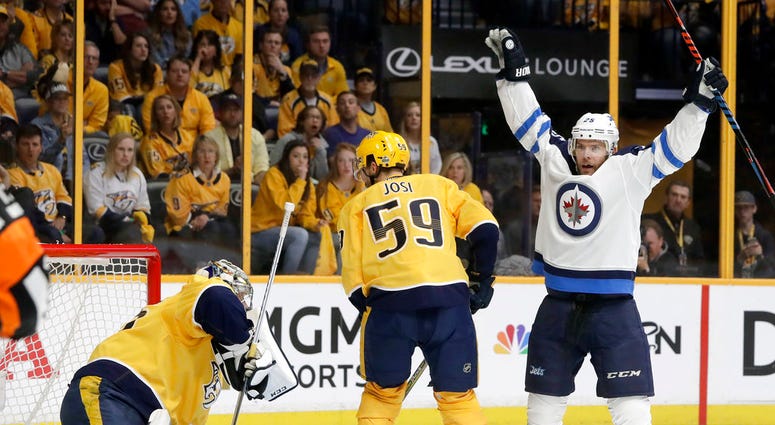 Paul Stastny, right, celebrates after teammate Tyler Myers, not shown, scored a goal against Nashville Predators goalie Pekka Rinne, DO NOT USE