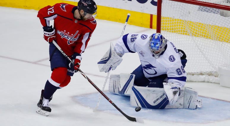 Washington Capitals center Evgeny Kuznetsov (92), from Russia, has his shot blocked by Tampa Bay Lightning goaltender Andrei Vasilevskiy (88), from Russia Capitals