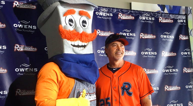 the Cleburne Railroaders mascot, Spike, left, poses with former Major League Baseball player and newly-signed player Rafael Palmeiro, DO NOT USE