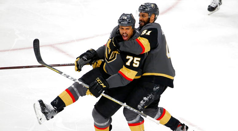 Vegas Golden Knights right wing Ryan Reaves, left, celebrates his goal with left wing Pierre-Edouard Bellemare, of France, during the third period in Game 1 DO NOT USE