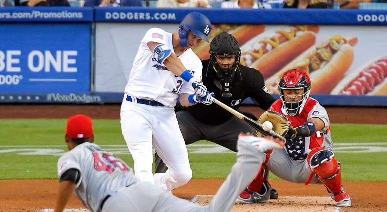 Los Angeles Dodgers' Joc Pederson, second from left, hits a solo home run as Pittsburgh Pirates starting pitcher Ivan Nova, left, and catcher Elias Diaz, right, watch DO NOT USE
