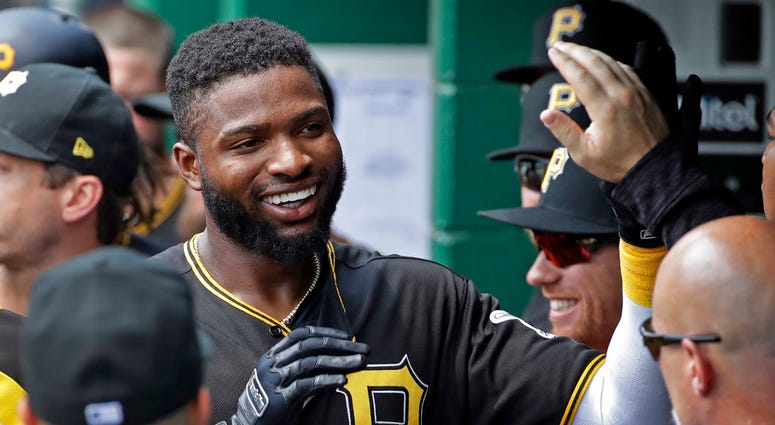 Pittsburgh Pirates' Gregory Polanco celebrates in the dugout after hitting a solo home run off Milwaukee Brewers starting pitcher Chase Anderson DO NOT USE