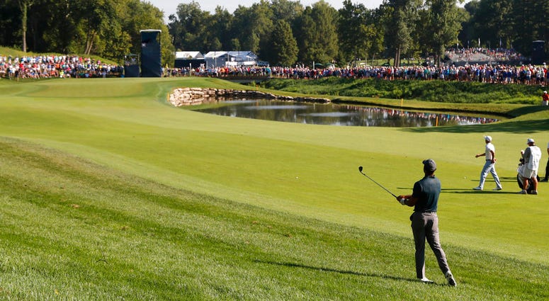 Tiger Woods watches his shot to the 11th green during the first round of the PGA Championship golf tournament at Bellerive Country Club, Thursday, Aug. 9, 2018, in St. Louis. DO NOT USE