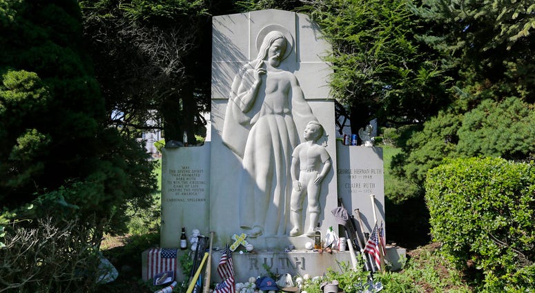 Items left by visitors decorate the grave of George Herman "Babe" Ruth and Claire Ruth at the Gates of Heaven Cemetery in Hawthorne, N.Y. DO NOT USE