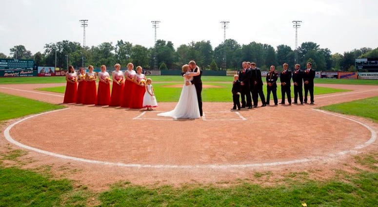 Kristopher Weisheit and Brittany Birk took their vows Saturday, Aug. 25, 2018, from home plate at League Stadium in Huntingburg, Ind., DO NOT USE