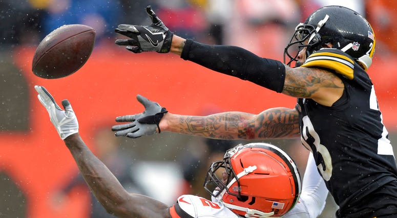 Cleveland Browns wide receiver Josh Gordon, bottom, cannot hold onto the ball under pressure from Pittsburgh Steelers defensive back Joe Haden, top, during the second half of an NFL football game, Sunday, Sept. 9, 2018, in Cleveland. DO NOT USE