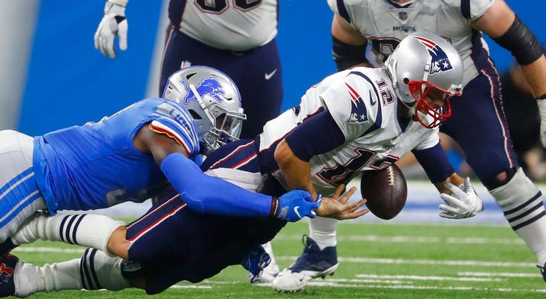 Detroit Lions linebacker Eli Harold sacks New England Patriots quarterback Tom Brady during the second half of an NFL football game, Sunday, Sept. 23, 2018, in Detroit. DO NOT USE