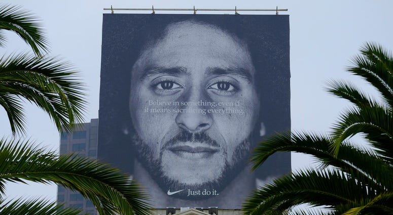 - In this Sept. 5, 2018, file photo palm trees frame a large billboard on top of a Nike store that shows former San Francisco 49ers quarterback Colin Kaepernick at Union Square in San Francisco. Nike Inc. reports earnings Tuesday, Sept. 25. DO NOT USE