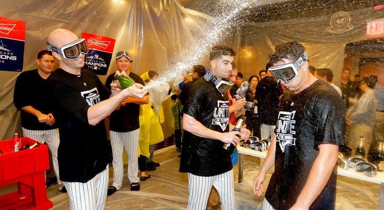The New York Yankees celebrate in the locker room after beating the Oakland Athletics 7-2 in the American League wild-card playoff baseball game, Wednesday, Oct. 3, 2018, in New York. DO NOT USE