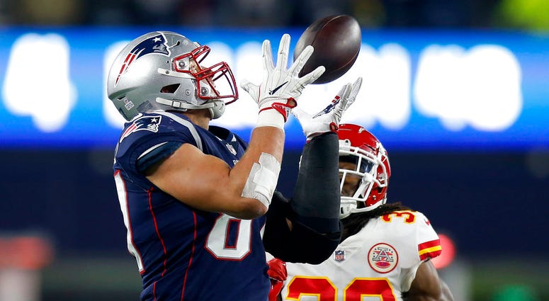 n this Sunday, Oct. 14, 2018, file photo, New England Patriots tight end Rob Gronkowski, left, catches a pass in front of Kansas City Chiefs safety Josh Shaw DO NOT USE