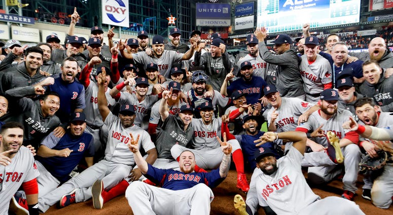 The Boston Red Sox pose for a picture after winning the baseball American League Championship Series against the Houston Astros on Thursday, Oct. 18, 2018, in Houston. Red Sox won 4-1. DO NOT USE