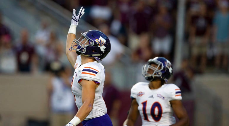 Northwestern State's Ryan Reed (8) waves for a fair catch on the opening kickoff against Texas A&M during an NCAA college football game Northwestern State's Ryan Reed (8) waves for a fair catch on the opening kickoff against Texas A&M during an NCAA college football game