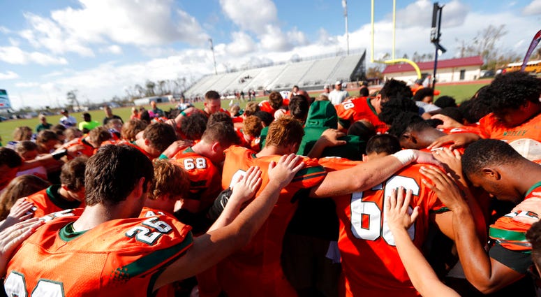 Coaches and players from Mosley High pray together after their loss to Pensacola High Coaches and players from Mosley High pray together after their loss to Pensacola High
