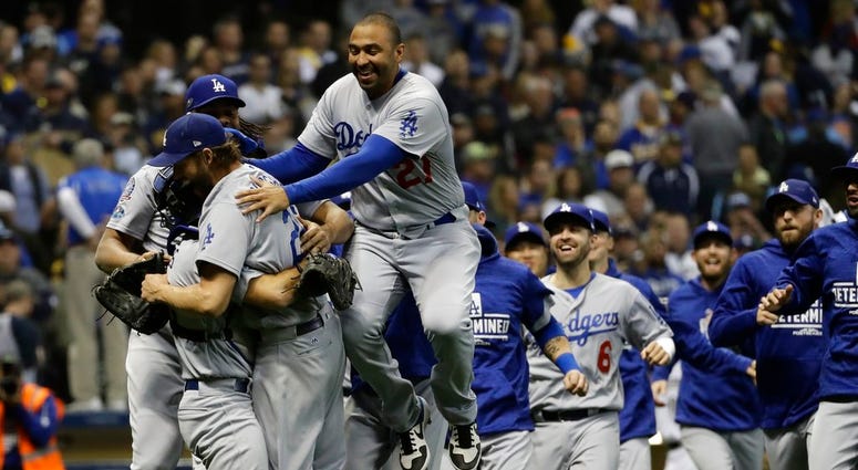 The Los Angeles Dodgers celebrate after Game 7 of the National League Championship Series baseball game Saturday, Oct. 20, 2018, in Milwaukee. DO NOT USE