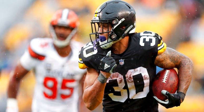 Pittsburgh Steelers running back James Conner (30) breaks away from Cleveland Browns defensive end Myles Garrett DO NOT USE