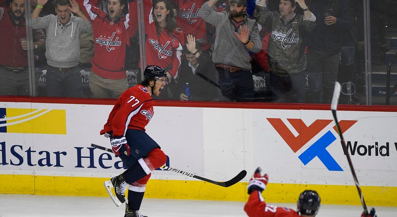 Washington Capitals right wing T.J. Oshie (77) celebrates his goal alongside center Evgeny Kuznetsov (92), of Russia, during the third period of an NHL hockey game against the Pittsburgh Penguins, Wednesday, Nov. 7, 2018, in Washington. DO NOT USE