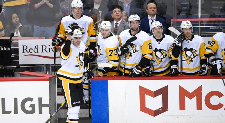 Pittsburgh Penguins center Evgeni Malkin, left, of Russia, gestures as he leaves the ice after he was given a match penalty during the third period DO NOT USE