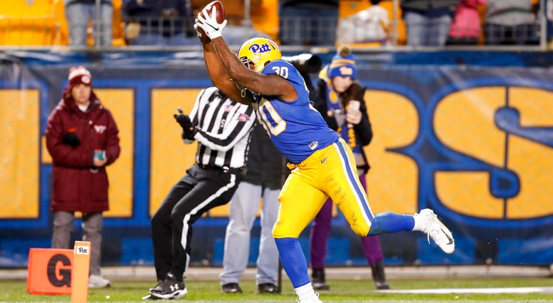 Pittsburgh running back Qadree Ollison (30) starts to sommersault as he goes into the end zone for a touchdown after a 97-yard run from scrimmage against Virginia Tech in the fourth quarter of an NCAA football game, Saturday, DO NOT USE