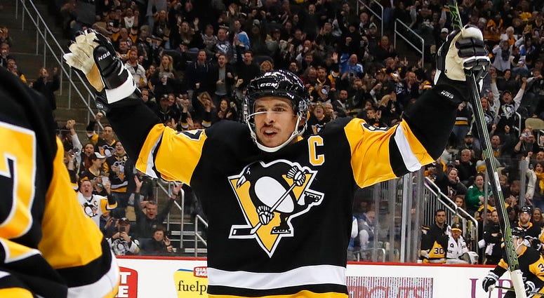 Pittsburgh Penguins' Sidney Crosby (87) celebrates a goal by Dominik Simon with teammates during the second period of an NHL hockey game against the Arizona Coyotes in Pittsburgh, Saturday, Nov. 10, 2018. DO NOT USE