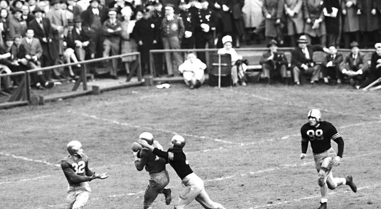 In this Nov. 9, 1946, file photo, Notre Dame's Emil Sitko (14) grabs a pass intended for Army's Bill West, In this Nov. 9, 1946, file photo, Notre Dame's Emil Sitko (14) grabs a pass intended for Army's Bill West,