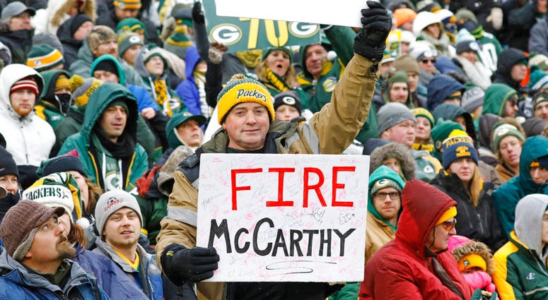 A fan holds up a sign directed towards Green Bay Packers head coach Mike McCarthy during the second half of an NFL football game against the Arizona Cardinals Sunday, Dec. 2, 2018, in Green Bay, Wis. DO NOT USE