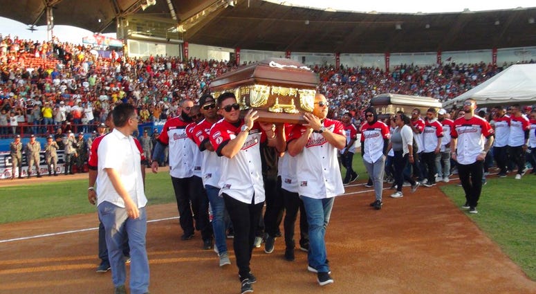 Players from the Cardenales de Lara baseball team carry the caskets of teammates and former major league players Luis Valbuena and Jose Castillo at a baseball stadium in Barquisimeto, Venezuela, Friday, Dec. 7, 2018 Players from the Cardenales de Lara baseball team carry the caskets of teammates and former major league players Luis Valbuena and Jose Castillo at a baseball stadium in Barquisimeto, Venezuela, Friday, Dec. 7, 2018