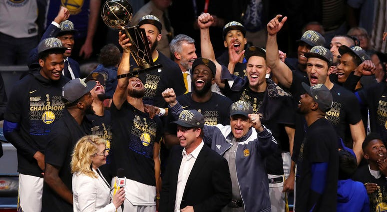 In this Friday, June 8, 2018, file photo, the Golden State Warriors celebrate after defeating the Cleveland Cavaliers 108-85 in Game 4 of basketball's NBA Finals to win the NBA championship, in Cleveland. DO NOT USE
