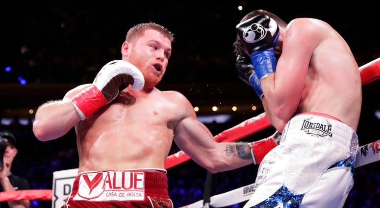 Mexico's Canelo Alvarez, left, punches England's Rocky Fielding during the third round of a WBA super middleweight championship boxing match Saturday, Dec. 15, 2018, in New York. Mexico's Canelo Alvarez, left, punches England's Rocky Fielding during the third round of a WBA super middleweight championship boxing match Saturday, Dec. 15, 2018, in New York.