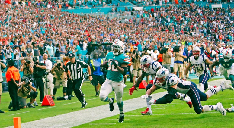 ile photo, Miami Dolphins running back Kenyan Drake (32) runs for a touchdown in the closing seconds of the second half of an NFL football game against the New England Patriots in Miami Gardens, Fla. DO NOT USE