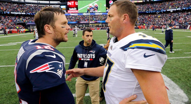 New England Patriots quarterback Tom Brady (12) and Los Angeles Chargers quarterback Philip Rivers New England Patriots quarterback Tom Brady (12) and Los Angeles Chargers quarterback Philip Rivers