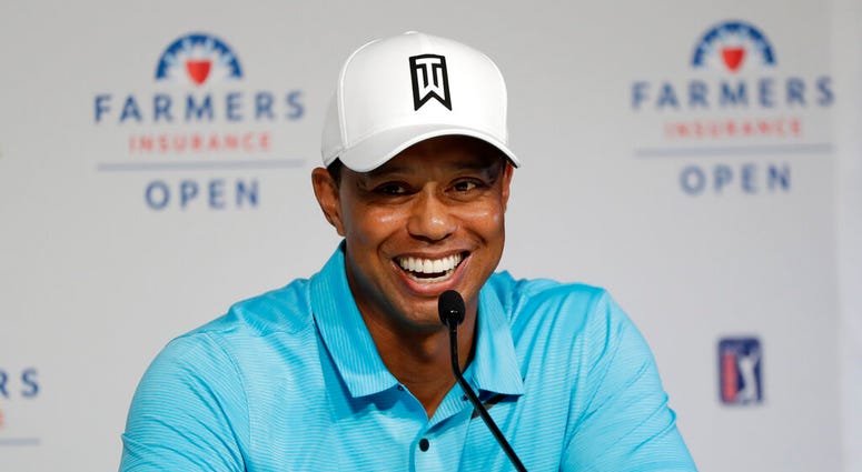 Tiger Woods laughs during a news conference after finishing on the north course at Torrey Pines Golf Course during the pro-am event at the Farmers Insurance Open golf tournament, in San Diego Tiger Woods laughs during a news conference after finishing on the north course at Torrey Pines Golf Course during the pro-am event at the Farmers Insurance Open golf tournament, in San Diego