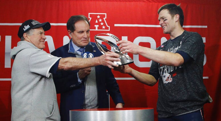 New England Patriots head coach Bill Belichick, left, hands off the championship trophy to quarterback Tom Brady after defeating the Kansas City Chiefs in the AFC Championship NFL football game New England Patriots head coach Bill Belichick, left, hands off the championship trophy to quarterback Tom Brady after defeating the Kansas City Chiefs in the AFC Championship NFL football game