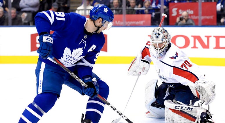 Washington Capitals goaltender Braden Holtby (70) stops Toronto Maple Leafs center John Tavares (91) AP DO NOT USE