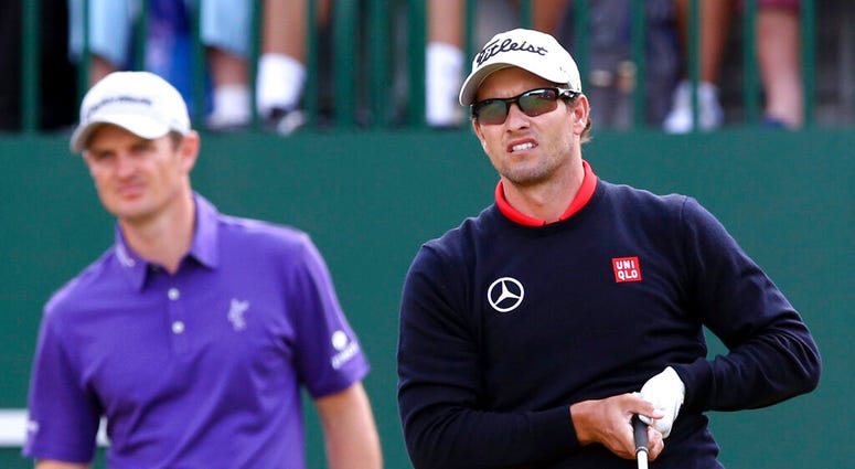 Adam Scott, of Australia, watches his shot off the first tee with Justin Rose, of England Adam Scott, of Australia, watches his shot off the first tee with Justin Rose, of England
