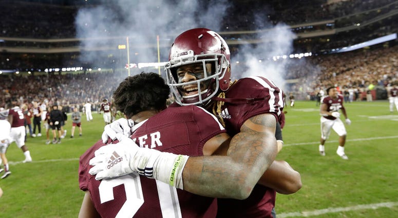 Texas A&M wide receiver Kendrick Rogers, right, celebrates with Charles Oliver (21) after their 74-72 win in seven overtimes against LSU Texas A&M wide receiver Kendrick Rogers, right, celebrates with Charles Oliver (21) after their 74-72 win in seven overtimes against LSU