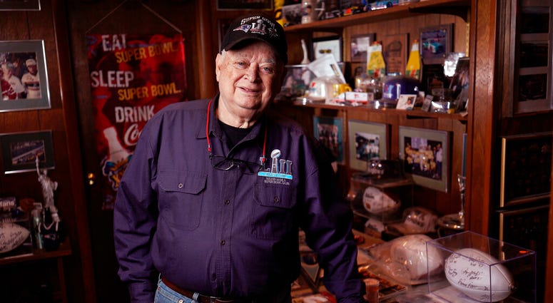 Don Crisman poses for a photo in his Kennebunk, Maine, home on Monday, Jan. 28, 2019, holding a Super Bowl LI ball signed by a few Patriots NFL football players. Don Crisman poses for a photo in his Kennebunk, Maine, home on Monday, Jan. 28, 2019, holding a Super Bowl LI ball signed by a few Patriots NFL football players.