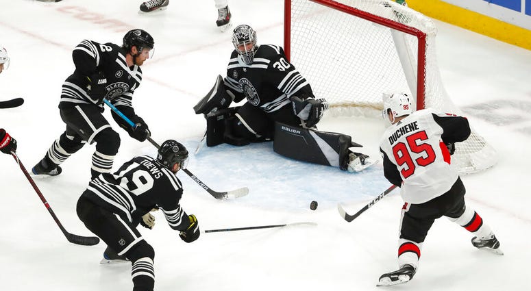 Ottawa Senators center Matt Duchene (95) is defended by Chicago Blackhawks Jonathan Toews (19), Duncan Keith (2) and goaltender Cam Ward (30) AP DO NOT USE
