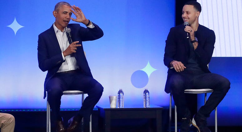 Former President Barack Obama, left, gestures as Golden State Warriors basketball player Stephen Curry laughs while speaking at the My Brother's Keeper Alliance Summit in Oakland, Calif., Tuesday, Feb. 19, 2019. DO NOT USE