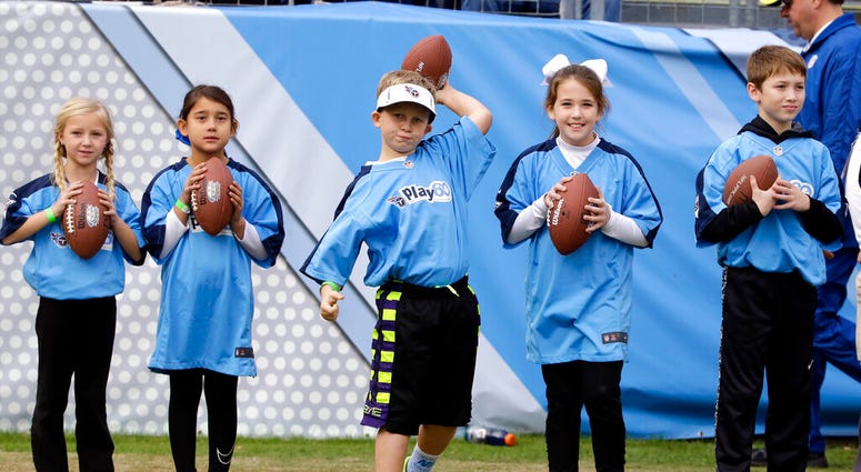kids get ready to take part in a halftime activity for the Play 60 exercise initiative at an NFL football game between the Tennessee Titans and the Jacksonville Jaguars in Nashville, Tenn. AP DO NOT USE