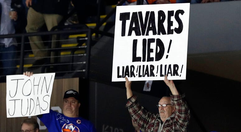 New York Islanders fans express their sentiments toward Toronto Maple Leafs center John Tavares, who left for Toronto in the offseason after saying he would stay with the Islanders, DO NOT USE