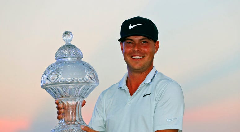 Keith Mitchell holds up his trophy after winning the Honda Classic golf tournament Sunday, March 3, 2019, in Palm Beach Gardens, Fla. Keith Mitchell holds up his trophy after winning the Honda Classic golf tournament Sunday, March 3, 2019, in Palm Beach Gardens, Fla.