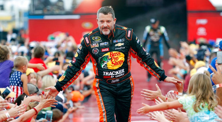 Tony Stewart is greeted by fans during driver introductions before the start of the NASCAR Sprint Cup auto race at Daytona International Speedway in Daytona Beach, Fla. Tony Stewart is greeted by fans during driver introductions before the start of the NASCAR Sprint Cup auto race at Daytona International Speedway in Daytona Beach, Fla.