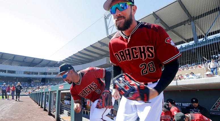 Arizona Diamondbacks' Steven Souza Jr. (28) and Eduardo Escobar (5) lead players out of the dugout before a spring training baseball game against the San Francisco Giants Thursday, March 14, 2019, in Scottsdale, Ariz. AP DO NOT USE