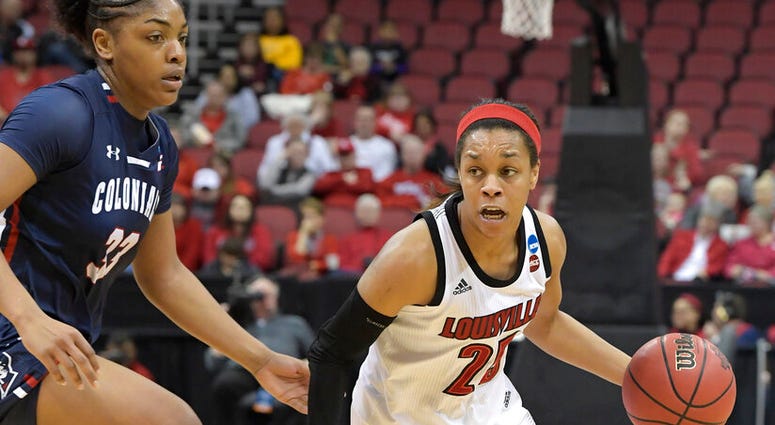 Louisville guard Asia Durr (25) drives past the defense of Robert Morris center Nneka Ezeigbo (33) during the second half of a first-round game in the NCAA women's college basketball tournament in Louisville, Ky., Friday, March 22, 2019 AP DO NOT USE