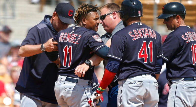 Cleveland Indians' Jose Ramirez (11) is helped to his feet after an injury during the third inning of the team's spring training baseball game against the Chicago White Sox on Sunday, March 24, 2019, in Glendale, Ariz. AP DO NOT USE